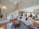 Spacious living room with hardwood floors, staircase, comfortable seating, and open access to the kitchen at 1103 Cooper Ln, Indian Trail, NC 28079