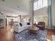 Bright living room with hardwood floors, large windows, comfortable seating, and an open view to kitchen at 1103 Cooper Ln, Indian Trail, NC 28079