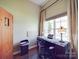 Cozy office space features a large window, hardwood floors and warm lighting at 1103 Cooper Ln, Indian Trail, NC 28079