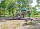 Community playground with play structure, benches, and pea gravel safety groundcover at 1103 Cooper Ln, Indian Trail, NC 28079