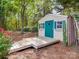 Charming backyard shed with custom details including flower boxes, wood deck, and decorative door at 1103 Cooper Ln, Indian Trail, NC 28079