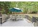 Back deck featuring outdoor furniture, grill, and an umbrella, perfect for entertaining guests at 11232 Tradition View Dr, Charlotte, NC 28269