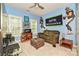 Bedroom with blue walls, fan, Seattle Seahawks decor, couch, and desk at 11232 Tradition View Dr, Charlotte, NC 28269