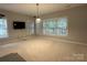 Bonus room with neutral paint, two windows, and light fixture - perfect for customizing as you desire at 11232 Tradition View Dr, Charlotte, NC 28269