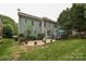 Two-story home with a backyard patio and landscaped yard with mature trees at 11232 Tradition View Dr, Charlotte, NC 28269