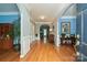 View of the foyer showcasing hardwood floors, blue accent walls, white trim, and an archway leading to other rooms at 11232 Tradition View Dr, Charlotte, NC 28269