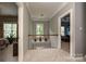 Upstairs hallway with carpeted floor, window view, and access to multiple rooms at 11232 Tradition View Dr, Charlotte, NC 28269