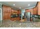 Bright kitchen features granite counters, stainless steel appliances, and ample wood cabinetry at 11232 Tradition View Dr, Charlotte, NC 28269