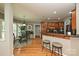 Open kitchen with stainless steel appliances, a breakfast bar, and a round dining table set near bay windows at 11232 Tradition View Dr, Charlotte, NC 28269