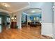 An open-concept living room with hardwood floors, blue accent walls, elegant furniture, and decorative lighting at 11232 Tradition View Dr, Charlotte, NC 28269