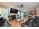 Spacious living room with a fireplace, hardwood floors, a ceiling fan, and leather sofas at 11232 Tradition View Dr, Charlotte, NC 28269