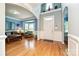 The living room features hardwood floors, blue accent walls, a bay window, and comfortable seating arrangements at 11232 Tradition View Dr, Charlotte, NC 28269