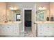 Spacious dual-vanity bathroom with marble floors and a door leading to the main bedroom at 11232 Tradition View Dr, Charlotte, NC 28269