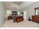 Spacious main bedroom featuring trey ceilings, two windows, a wooden bed set and an ensuite bath at 11232 Tradition View Dr, Charlotte, NC 28269