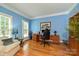Office space with hardwood floors, blue walls, a desk, office chair, and a window with lots of natural light at 11232 Tradition View Dr, Charlotte, NC 28269