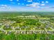 Expansive aerial view of a residential neighborhood showcasing tree-lined streets and well-maintained homes in a lush setting at 1128 Rosecliff Dr, Marvin, NC 28173