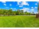 Spacious, well-maintained lawn enclosed by a classic white picket fence, offering privacy and a serene outdoor space at 1128 Rosecliff Dr, Marvin, NC 28173