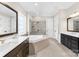 Bright and airy bathroom featuring double vanity, large tub with shower, and neutral tile work at 1128 Rosecliff Dr, Marvin, NC 28173
