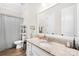 Well-lit bathroom featuring a granite countertop, a toilet, and plenty of storage shelves at 1128 Rosecliff Dr, Marvin, NC 28173