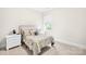 Bright bedroom featuring a decorative headboard, a window with blinds, and stylish bedside tables and lamps at 1128 Rosecliff Dr, Marvin, NC 28173