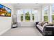 Bright bedroom with large windows offering serene views, and a comfortable couch, perfect for relaxation at 1128 Rosecliff Dr, Marvin, NC 28173