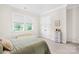 Airy bedroom with natural light, featuring twin windows, and warm, neutral-toned decor at 1128 Rosecliff Dr, Marvin, NC 28173