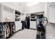Organized walk-in closet with shelving, drawers, hanging rods, and exercise equipment at 1128 Rosecliff Dr, Marvin, NC 28173