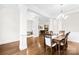 Open-concept dining area with hardwood floors and seamless transition to living room and office space at 1128 Rosecliff Dr, Marvin, NC 28173