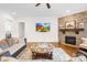 Comfortable living room features a stone fireplace, hardwood floors, and a decorative center table at 1128 Rosecliff Dr, Marvin, NC 28173