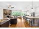 Open concept living area showing a stone fireplace with a seamless flow to the dining and kitchen area at 1128 Rosecliff Dr, Marvin, NC 28173