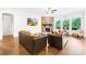 Cozy living room with a stone fireplace, hardwood floors, and large windows with scenic views at 1128 Rosecliff Dr, Marvin, NC 28173