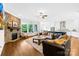 Open concept living room featuring a stone fireplace and seamlessly connected to the modern kitchen at 1128 Rosecliff Dr, Marvin, NC 28173