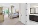 Serene main bedroom with four poster bed, fan, a glimpse into the ensuite, and plenty of natural light at 1128 Rosecliff Dr, Marvin, NC 28173