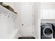 Convenient mudroom with storage bench, coat hooks, and direct access to laundry appliances at 1128 Rosecliff Dr, Marvin, NC 28173