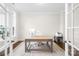 Home office with a large desk, light wood floors, and a modern, minimalist design at 1128 Rosecliff Dr, Marvin, NC 28173