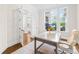 Bright home office with ample natural light, wood floors, and a comfortable office chair at 1128 Rosecliff Dr, Marvin, NC 28173