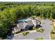 Aerial view of the community pool and clubhouse, surrounded by lush greenery and ample parking at 1149 Grand Oak Dr, Waxhaw, NC 28173