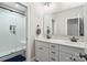 Modern bathroom features a dual sink vanity with quartz countertop and a sleek glass-enclosed shower at 1149 Grand Oak Dr, Waxhaw, NC 28173