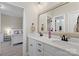 Elegant bathroom featuring a double vanity, white cabinets, and a large mirror at 1149 Grand Oak Dr, Waxhaw, NC 28173