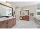 Elegant bathroom with double vanities, marble flooring, and a separate makeup area at 1149 Grand Oak Dr, Waxhaw, NC 28173