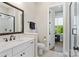 Bright bathroom with a white vanity, large mirror, and access to a glass-enclosed shower at 1149 Grand Oak Dr, Waxhaw, NC 28173