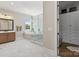 Luxurious bathroom with a soaking tub, glass-enclosed shower, and custom cabinetry at 1149 Grand Oak Dr, Waxhaw, NC 28173