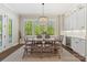 Sunlit dining room with a wooden table, ample seating, and a built-in bar with a wine fridge at 1149 Grand Oak Dr, Waxhaw, NC 28173