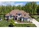 Beautiful gray two-story home featuring a manicured front lawn, stone accents, and a symmetrical facade at 1149 Grand Oak Dr, Waxhaw, NC 28173