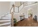 Elegant foyer with hardwood floors, a staircase with white railings, and a view of the living room at 1149 Grand Oak Dr, Waxhaw, NC 28173