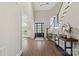Grand foyer with a dark front door, hardwood floors, a staircase, and a view of the living room at 1149 Grand Oak Dr, Waxhaw, NC 28173