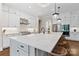 Open kitchen featuring a large white marble center island with seating and modern pendant lighting at 1149 Grand Oak Dr, Waxhaw, NC 28173