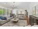 Open-concept living room with hardwood floors, a modern chandelier, and access to the kitchen at 1149 Grand Oak Dr, Waxhaw, NC 28173