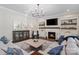 Spacious living room features a fireplace, built-in bookshelves, hardwood floors, and a stylish rug at 1149 Grand Oak Dr, Waxhaw, NC 28173