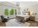 Spacious main bedroom with a large window, tray ceilings, and elegant furnishings at 1149 Grand Oak Dr, Waxhaw, NC 28173